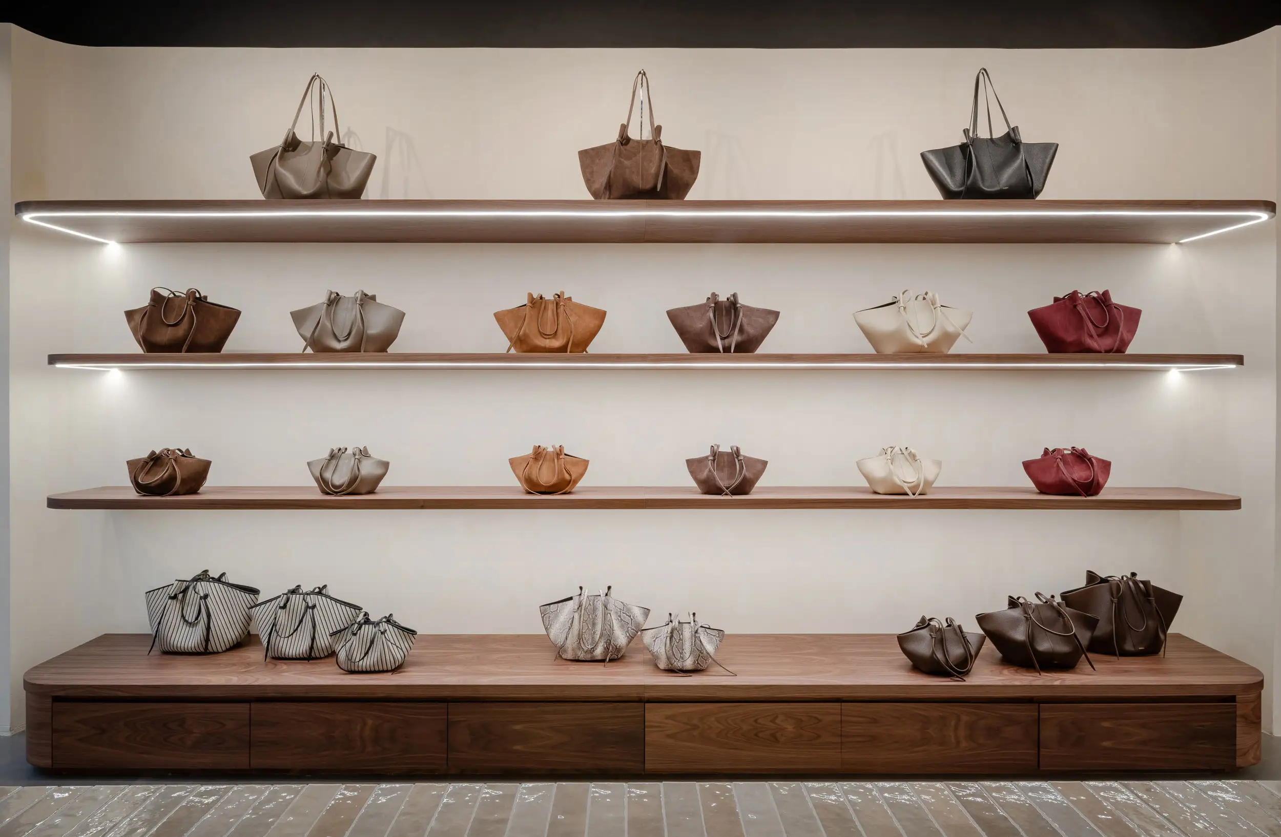 Bespoke timber display shelving with handbags in a fashion retail store fit-out